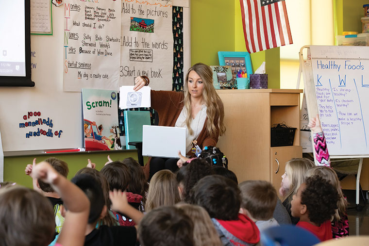 Missouri State student teacher reading to elementary classroom