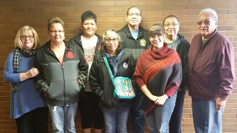 CDR staff stand with members of the Omaha Tribe.