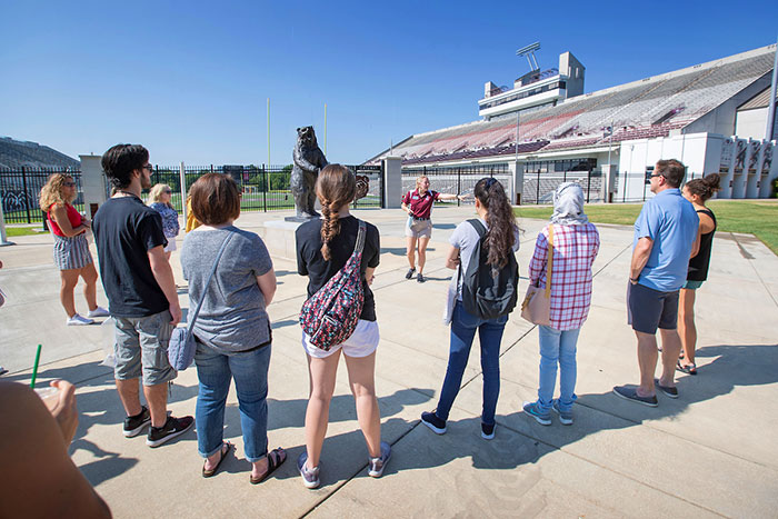 MSU student tour guide stopping at Plaster Stadium
