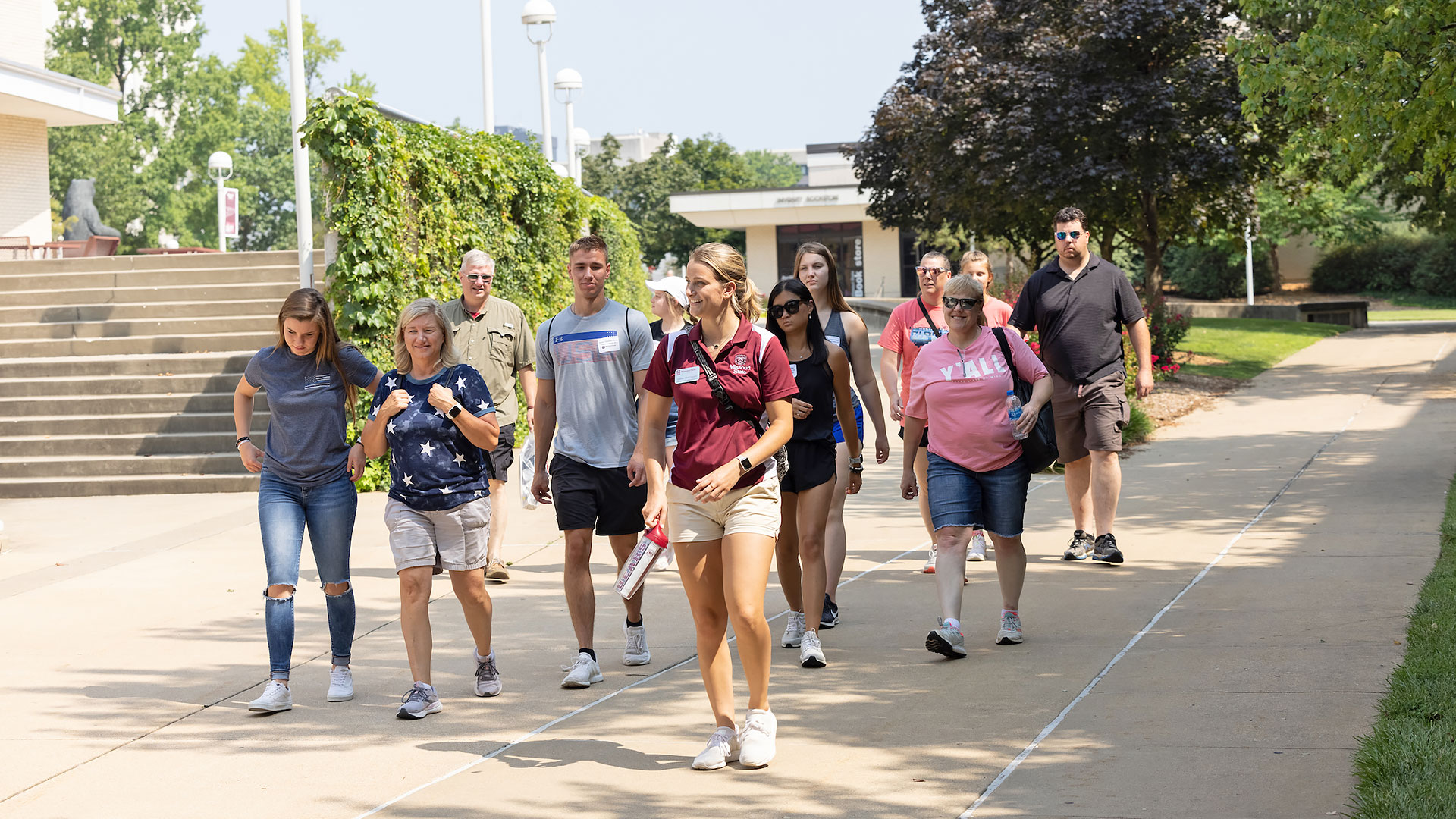 Future students and their families tour campus near the Plaster Student Union on a sunny day.