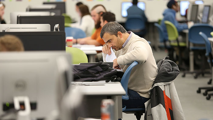 A student working at a station in a computer lab