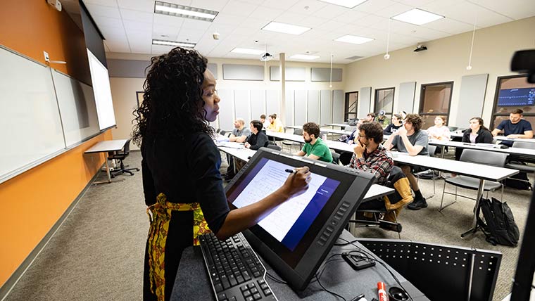 Electrical engineering professor Dr. Tayo Obafemi Ajayi teaching students in a classroom.