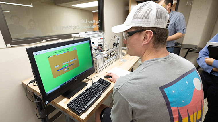A student uses a computer program to complete a lab exercise.