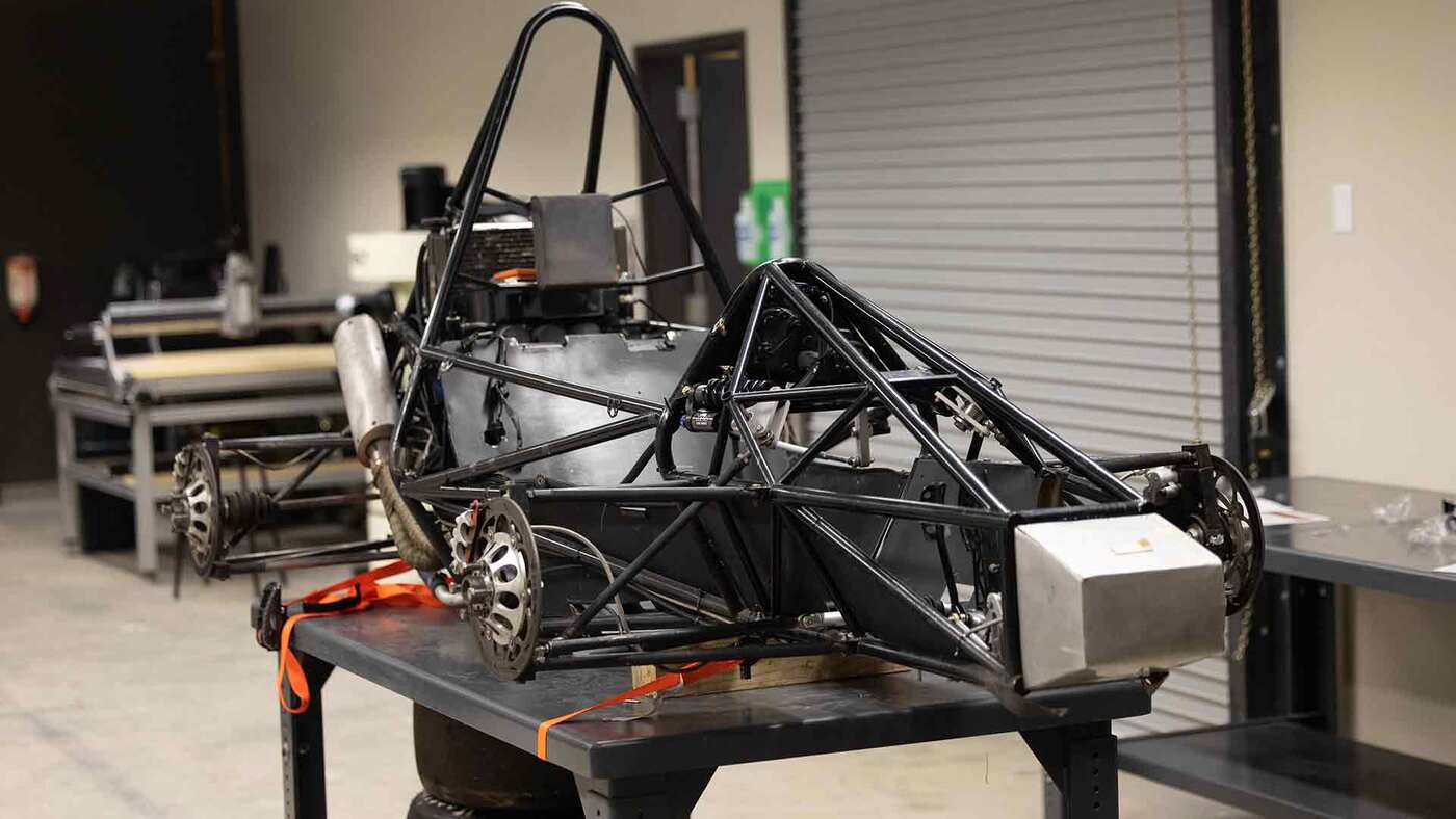 A small, bare-bones vehicle made from steel and aluminum.