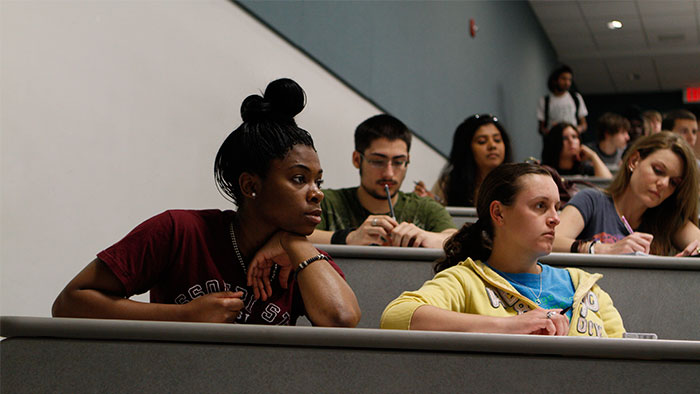 Students listening carefully to their professor during a lecture.