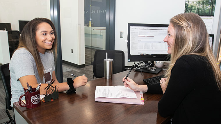 A Missouri State business advisor meeting with a student.