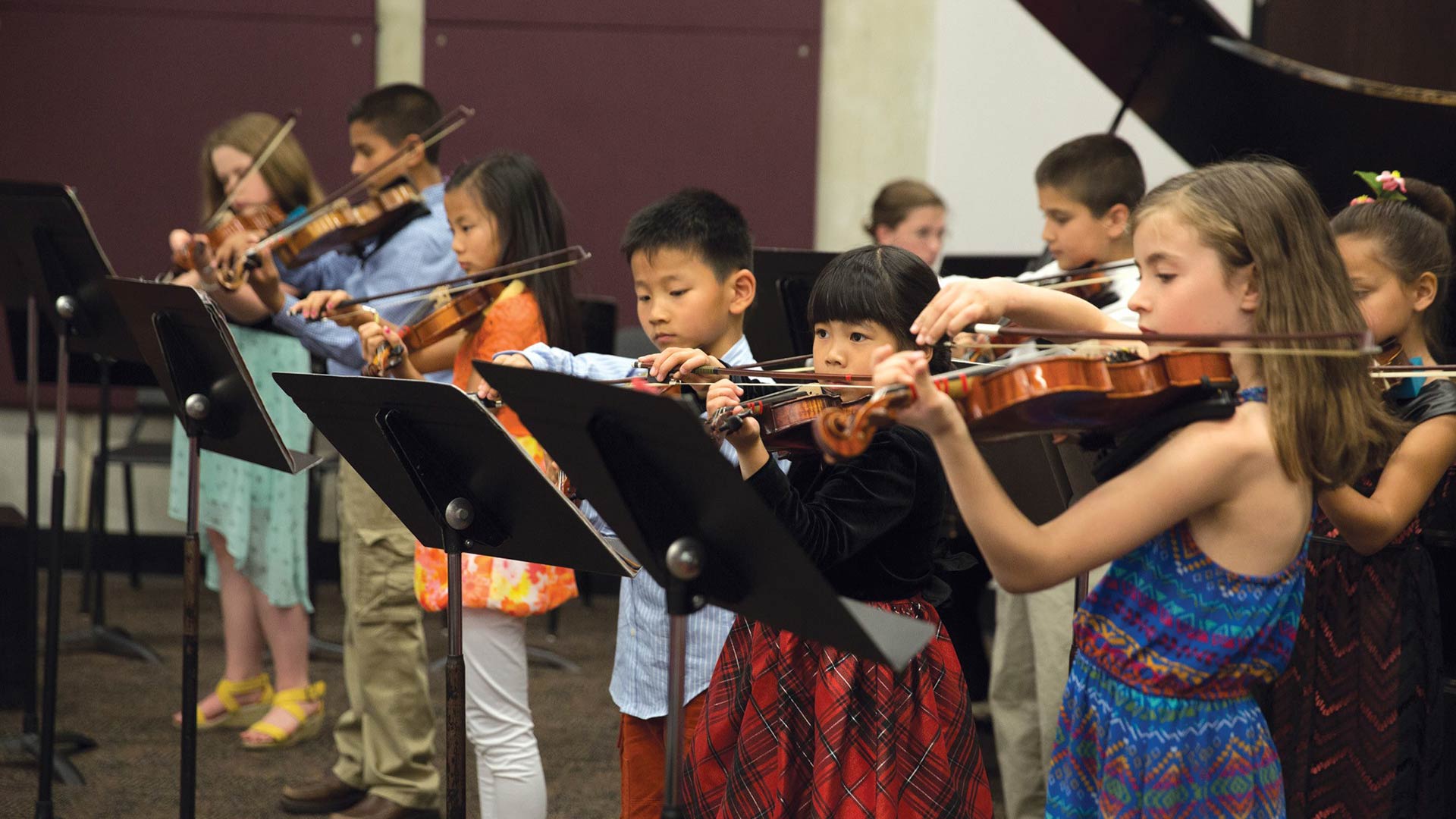 Group of students play violin together
