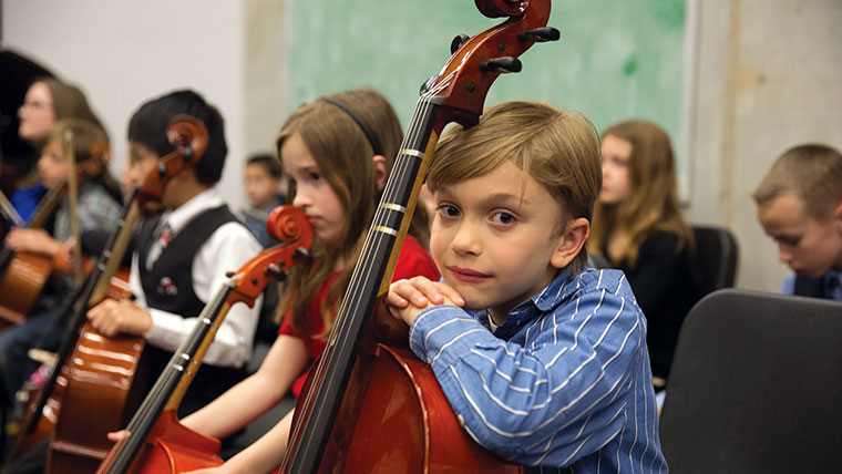 Close up of student with string instrument