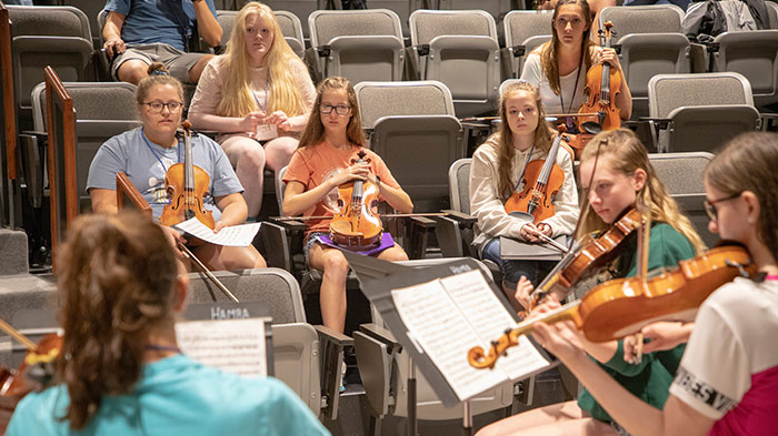 Student ensemble plays for peers