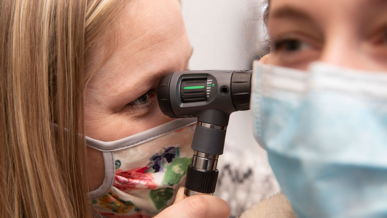 Examining patient's ear.