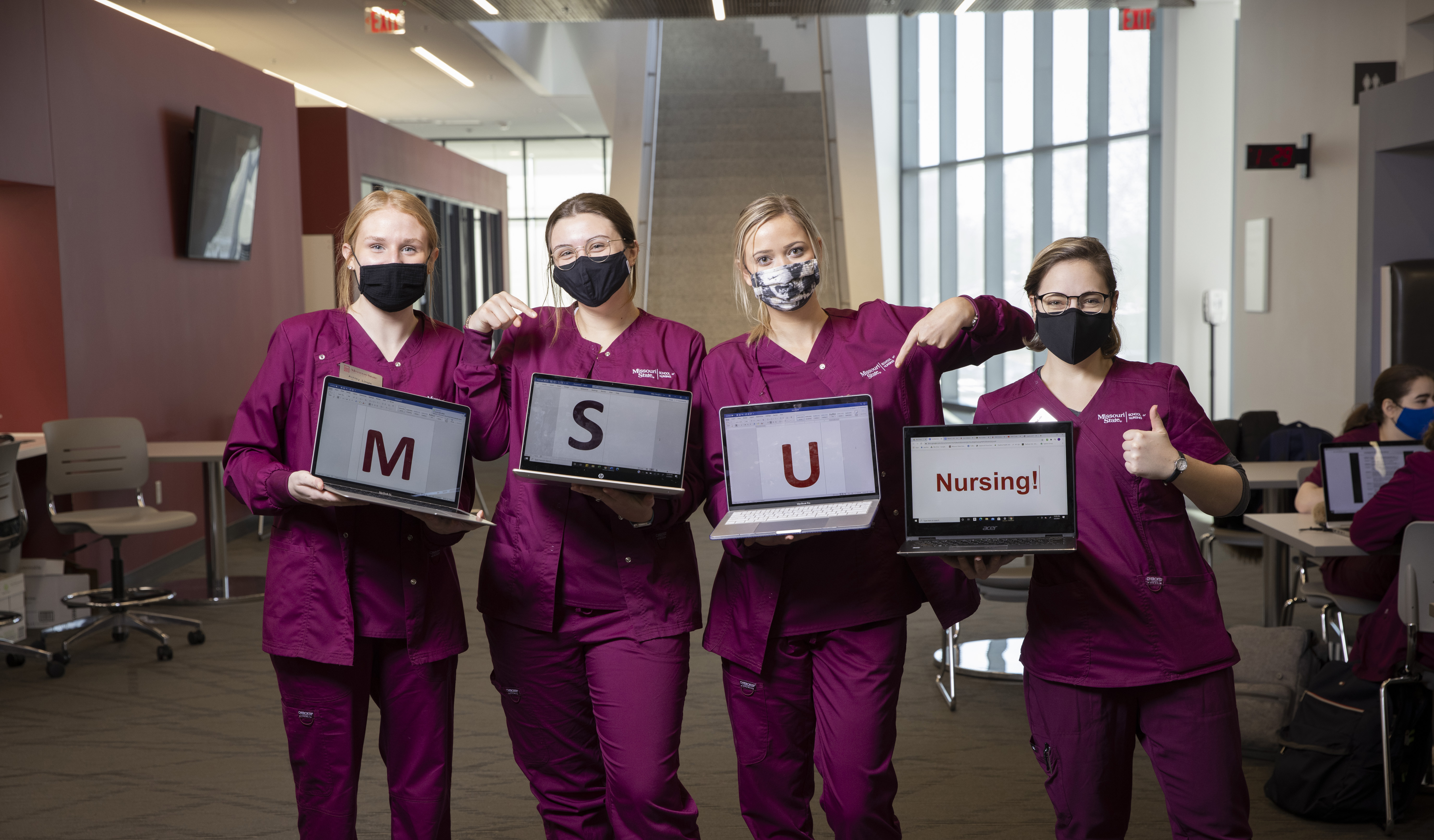 Nursing students displaying M S U Nursing on laptops.