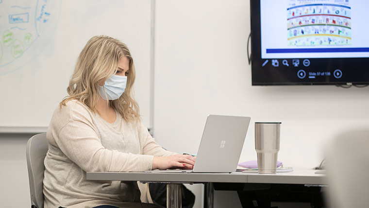 Nursing student using laptop.