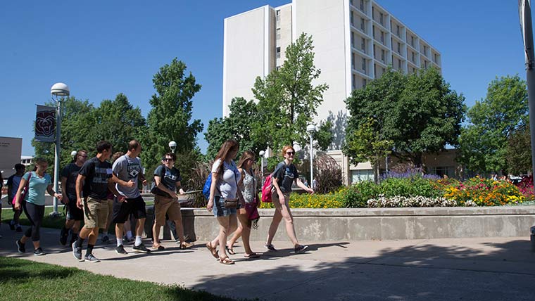 Students walking toward residence halls.