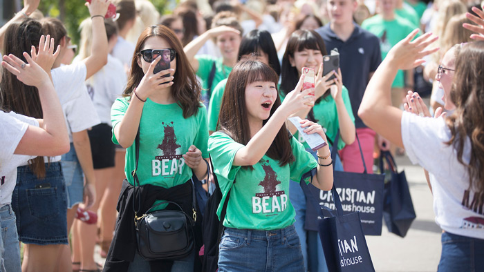 Students take photos while walking through Bear Path