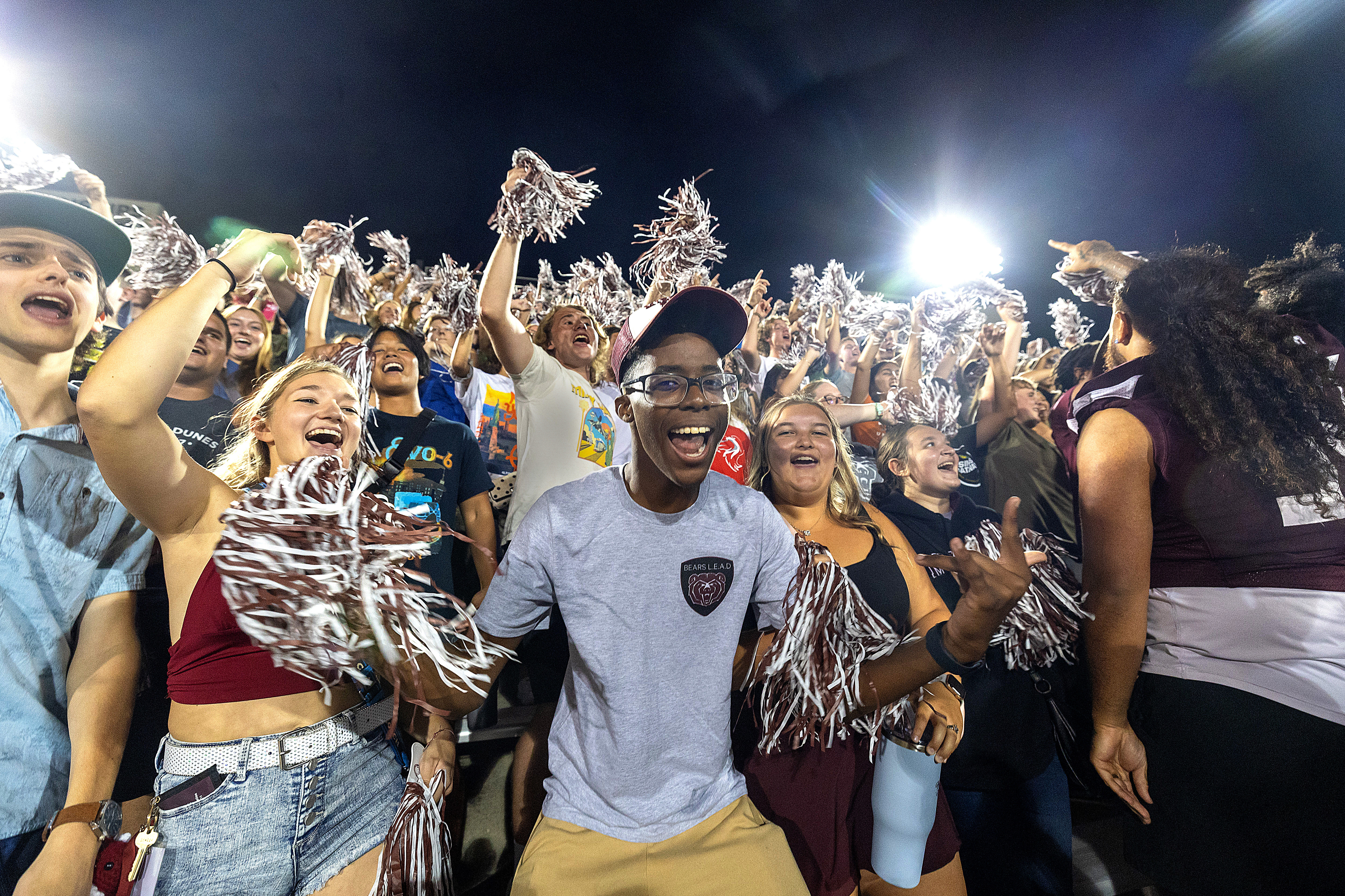 Students cheer in the stands of Plaster Stadium after a football game