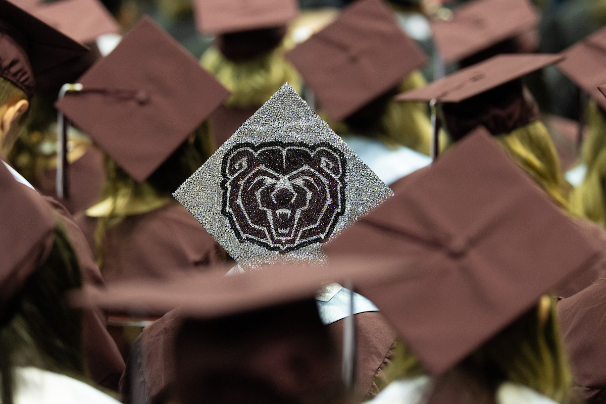 Students wearing maroon caps at graduation