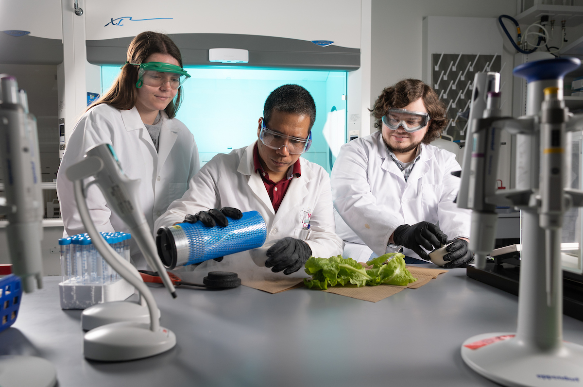 Students and professor working in science lab