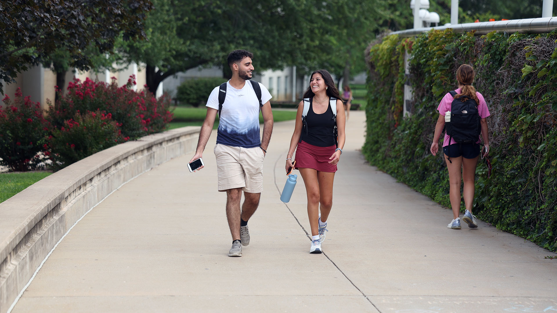 Two Missouri State students talking to each other while walking to class.