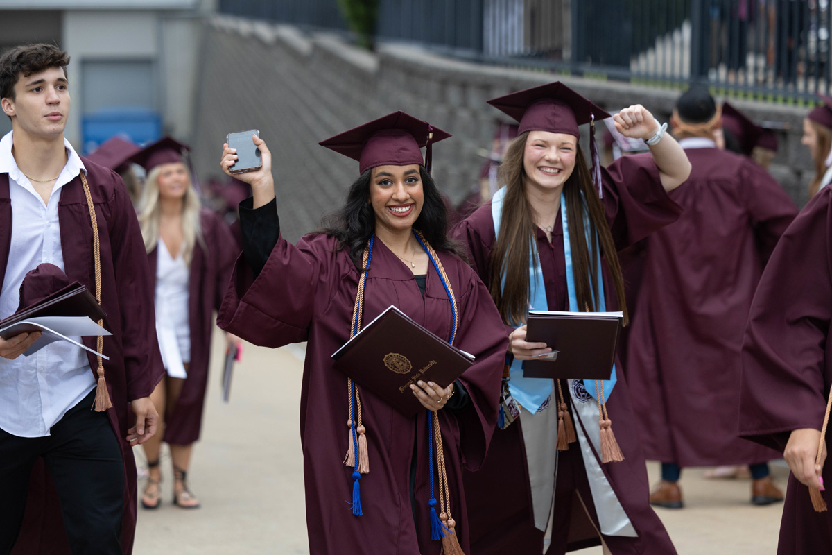 Students in cap and gown regalia at graduation