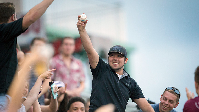 Smiling student who just caught a baseball at a Missouri State game