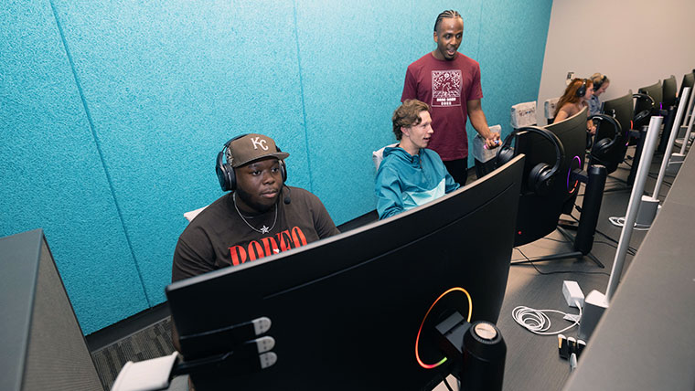 Missouri State individuals sitting in front of computers participating in e-sports leagues