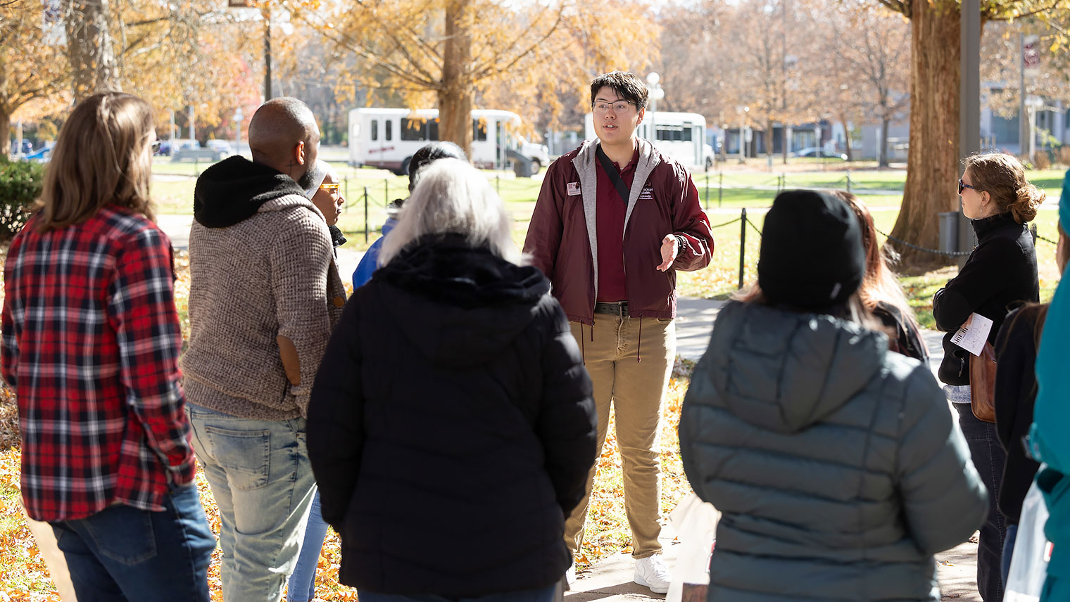 A student tour guide leads a tour of campus