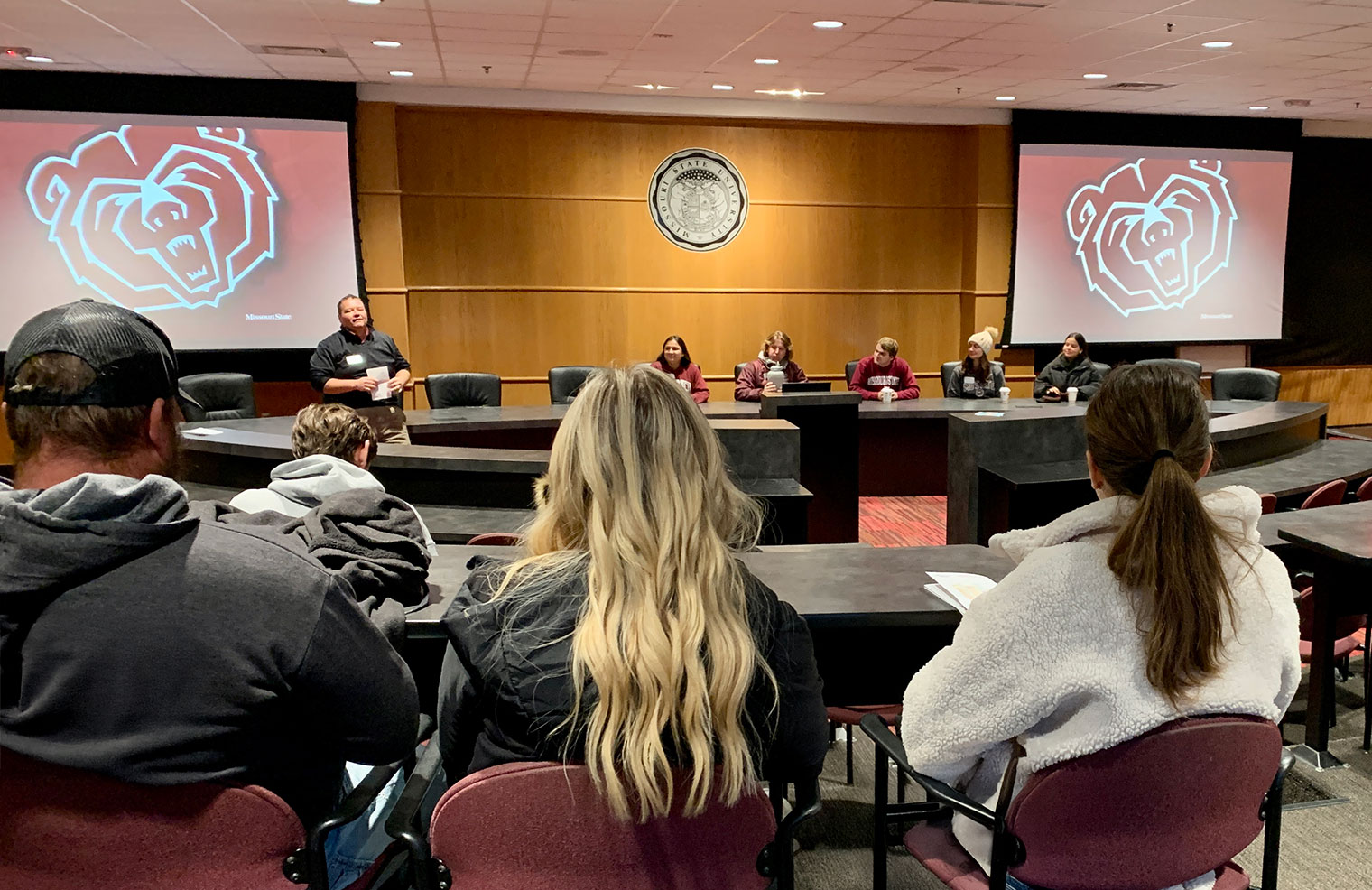 Visitors listening to a student panel presentation