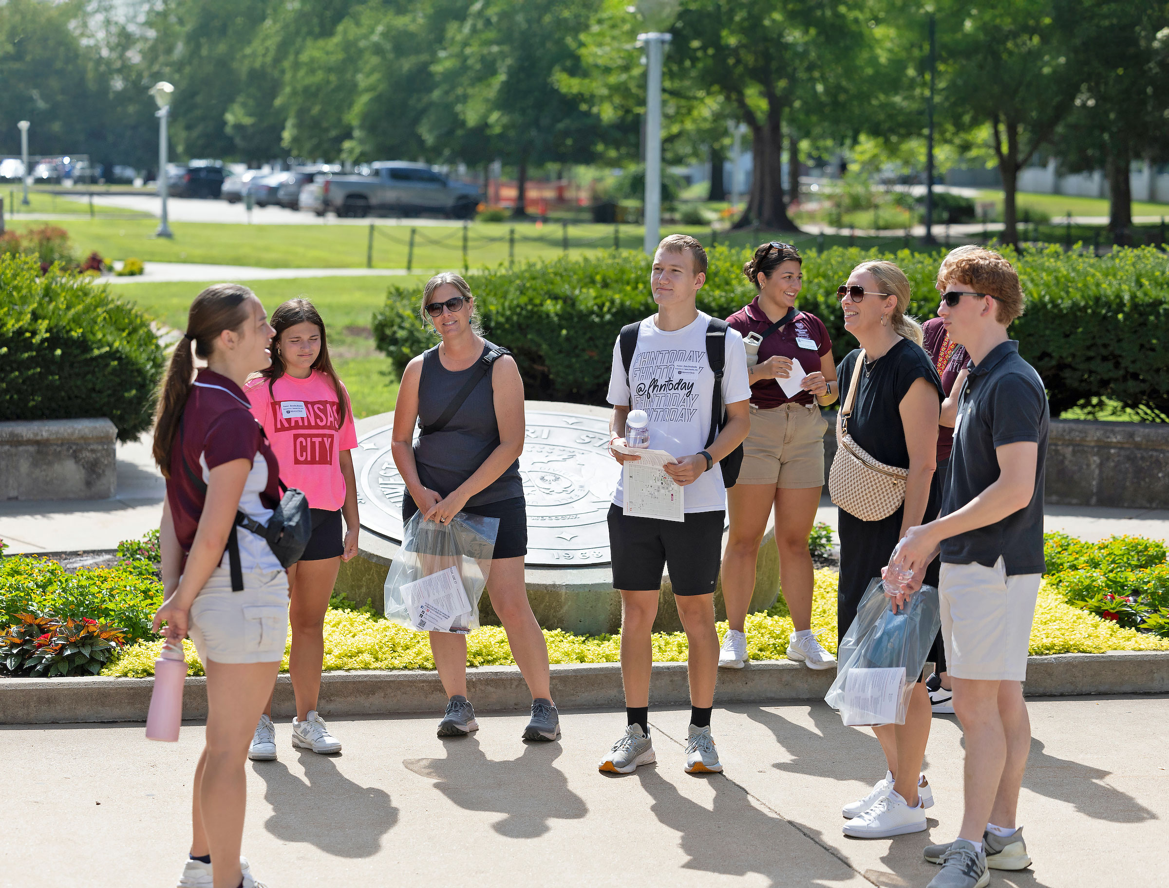 Future students and their families tour campus near the Plaster Student Union on a sunny day.