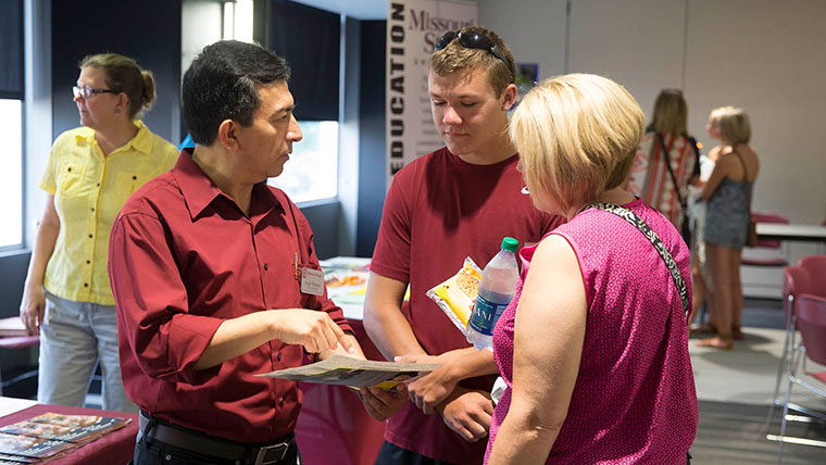 Missouri State faculty member talking with admitted student and his mother