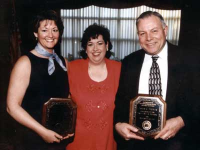 Kathy Davis standing between Staff Reciepent Caron Daugherty and Faculty Reciepent Jim Moyer