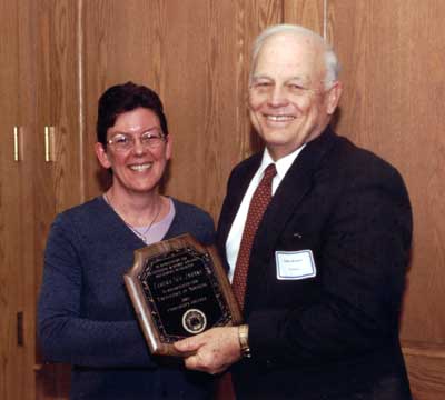 President Keiser congratulates faculty recipient Temera Jahnke