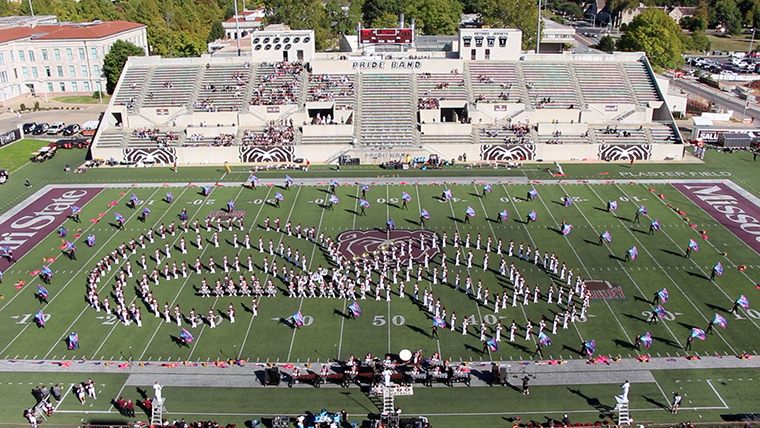 Bands march on the football field during the Ozarko Marching Festival at Missouri State University