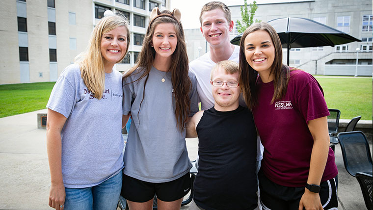 Bear POWER program participants and ambassadors smiling while enjoying a sunny day on campus. 