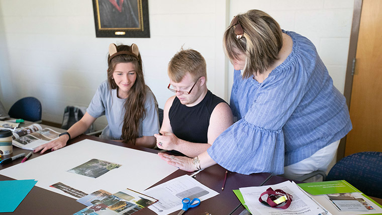 A Bear POWER teacher assisting students within the Missouri State classroom. 