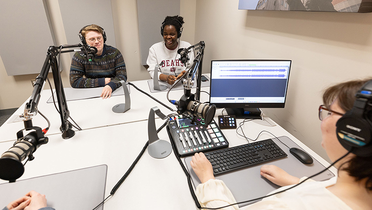 Four students in podcast studio
