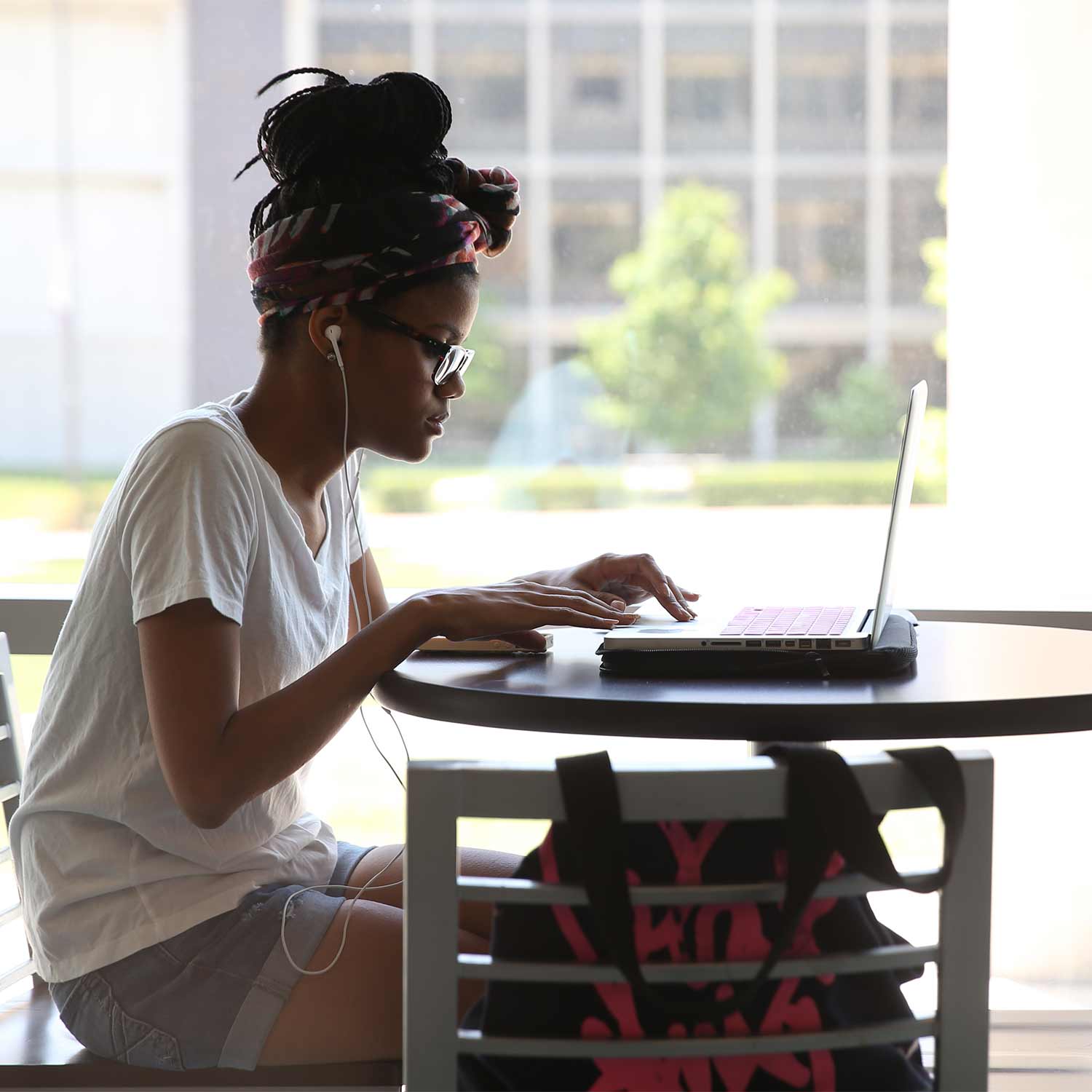 A student using her laptop outside of Meyer Library.