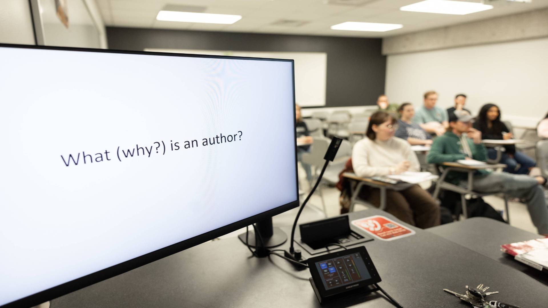 Classroom computer with students in background