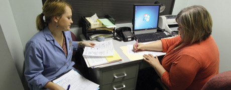 Two ladies filling out papers