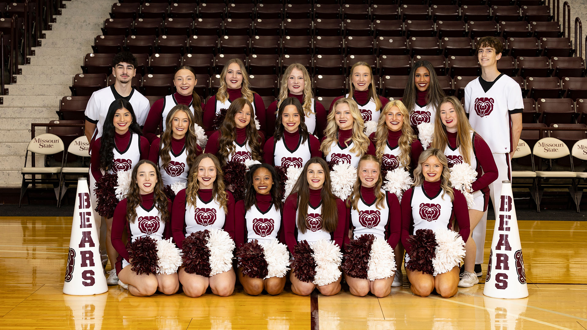 Missouri State cheerleaders line up in three rows for a group photo in Hammons Student Center.