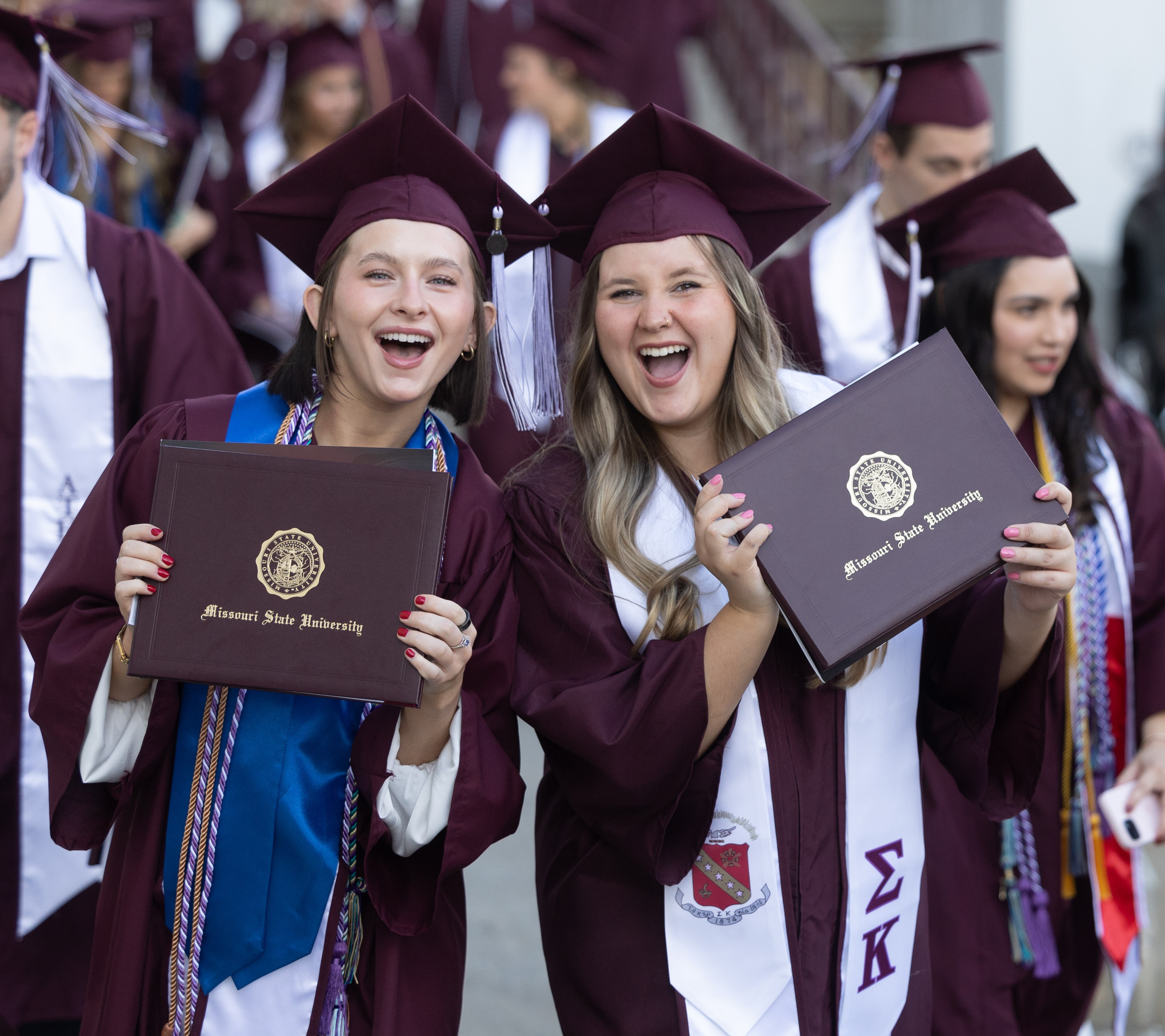 Smiling grads at commencement.