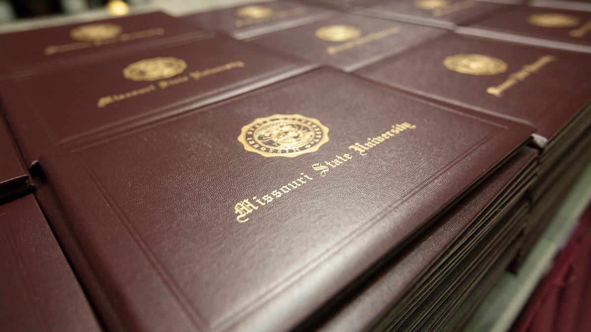 Stack of Missouri State University diploma covers