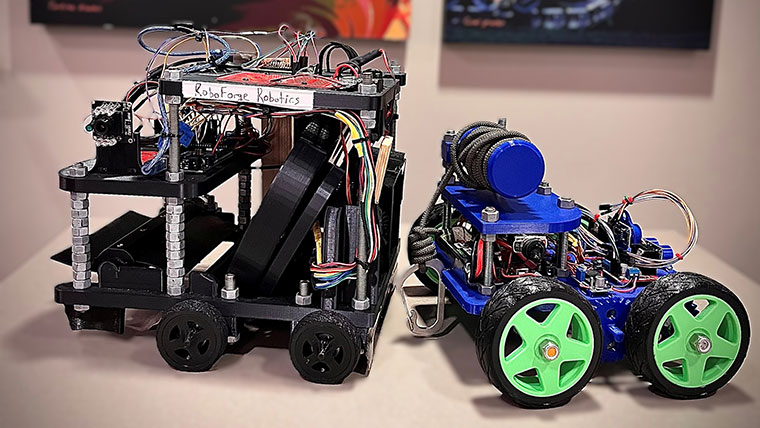 Two robotic machines side-by-side on a table.