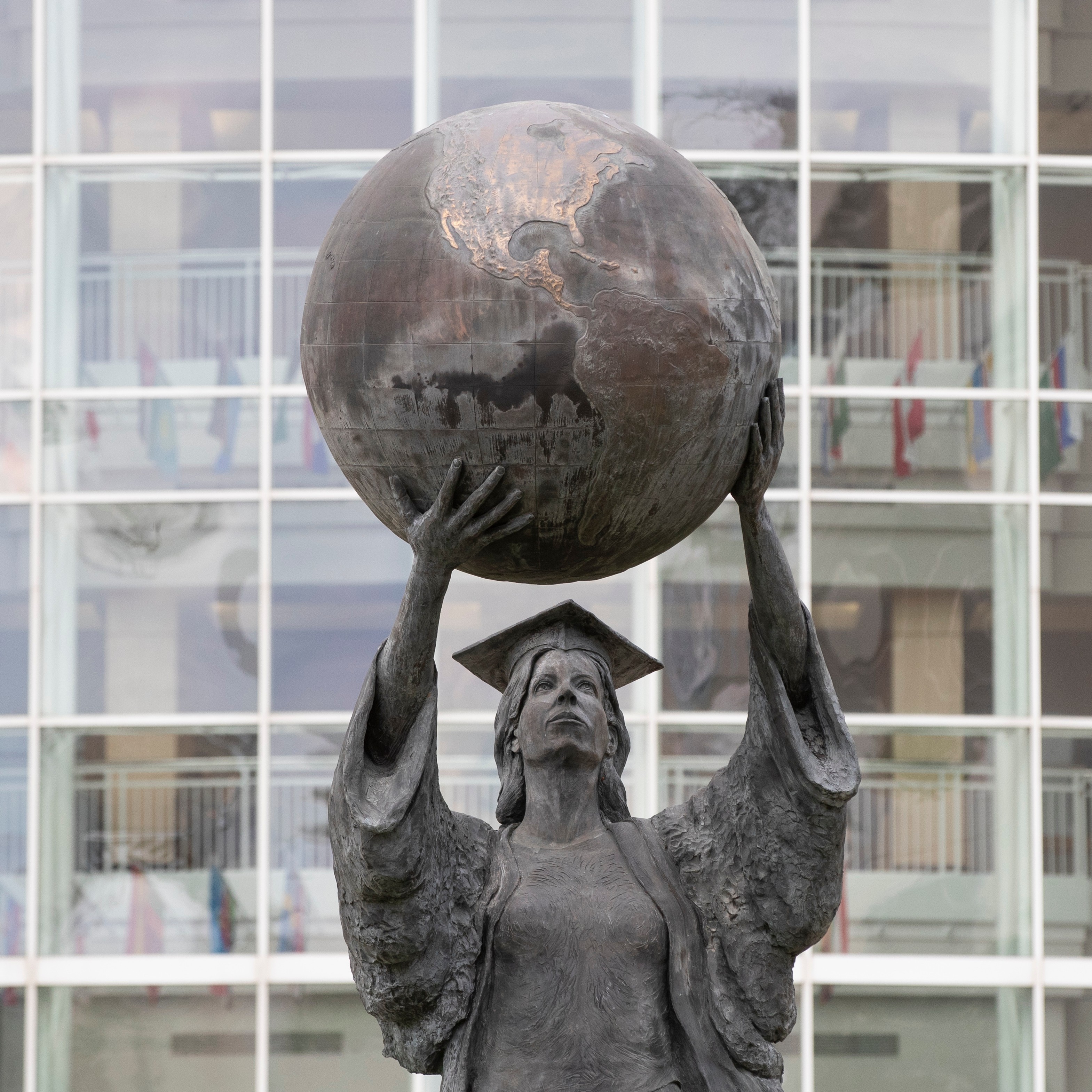 statue of a woman holding the globe