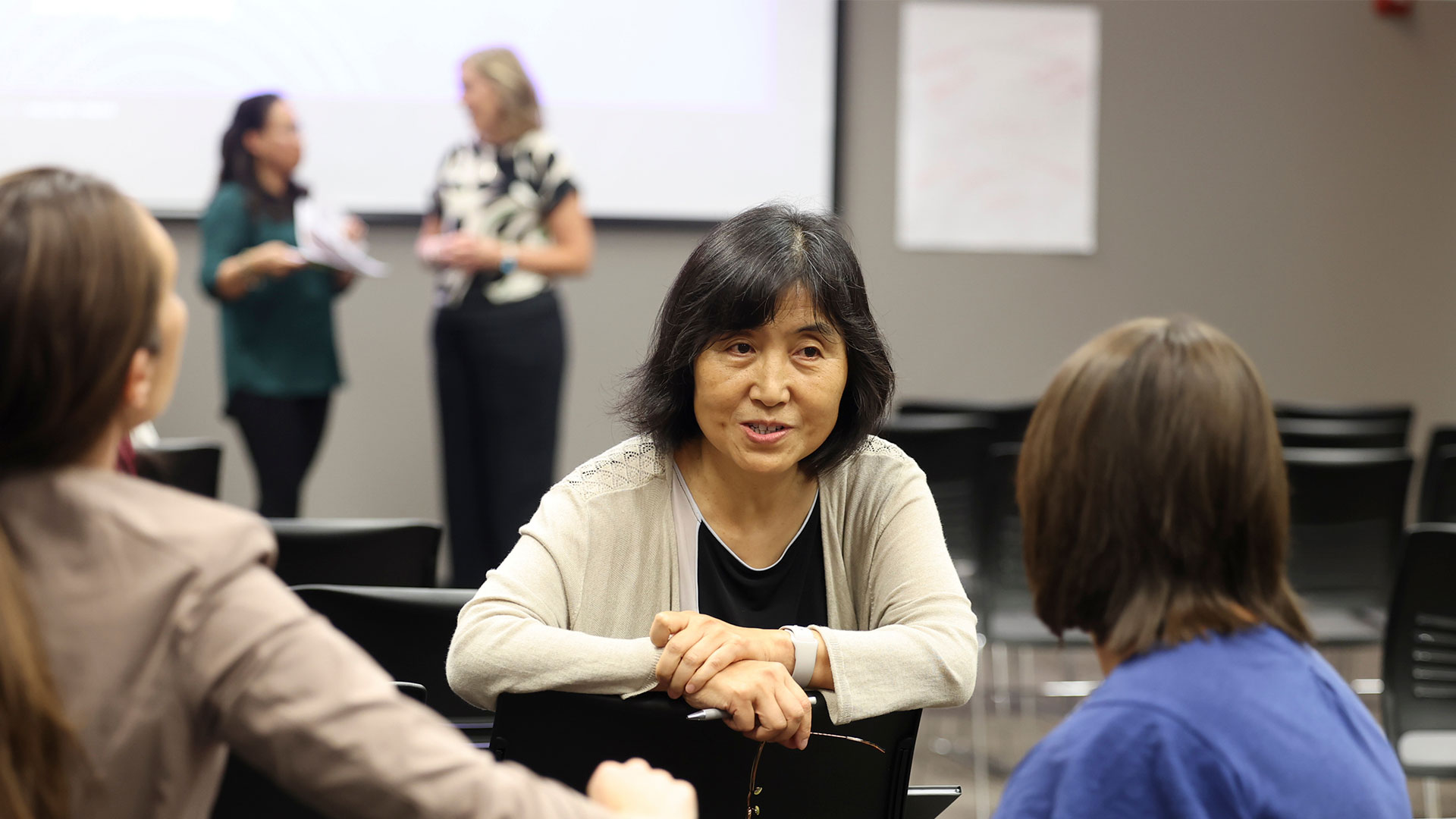 Attendees speaking at the Showcase for Teaching and Learning event.