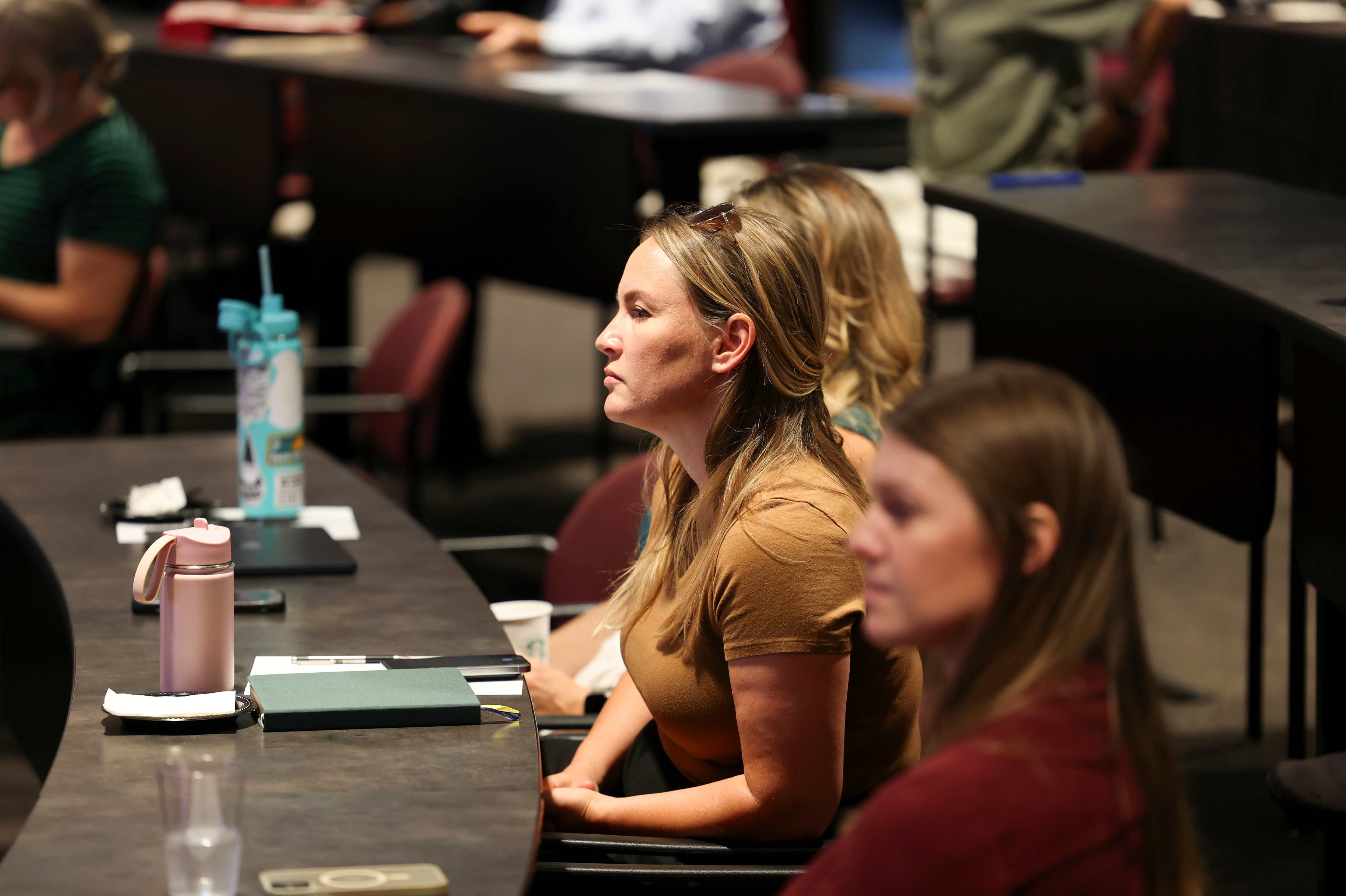 faculty members listen to a presentation at Showcase 2025