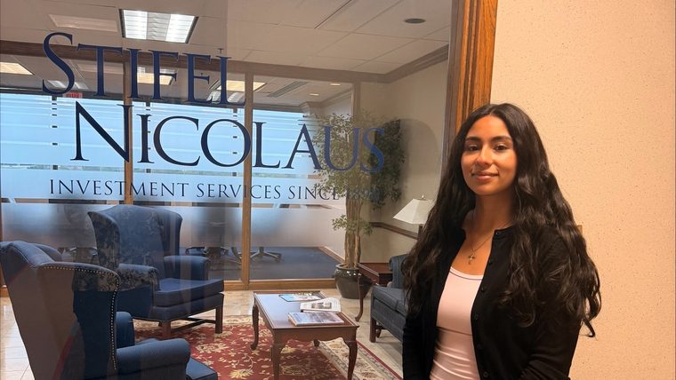 Brithny Saucedo, Missouri State financial planning student and CFP Board Student Liaison, standing outside the Stifel Nicolaus office.