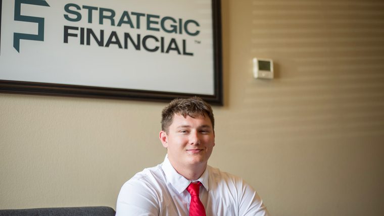 Gage Smart, Missouri State financial planning graduate, seated in the Strategic Financial office in Springfield.