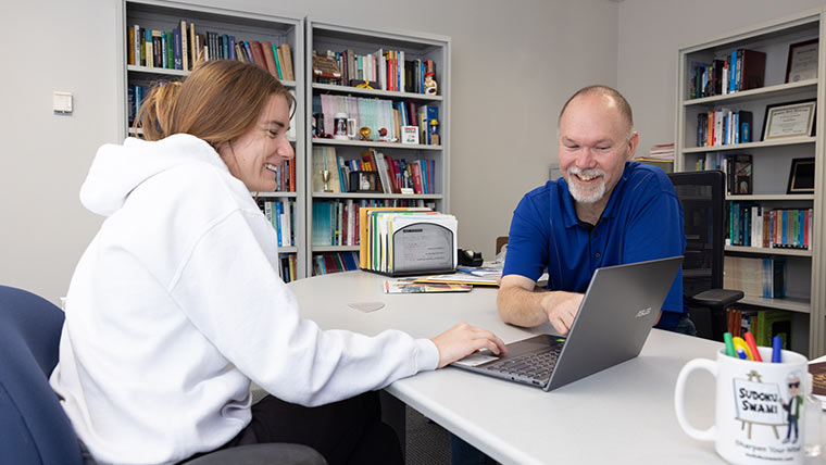 Faculty helping a student.