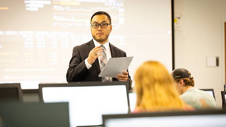 Finance faculty teaching a course in the trading lab.