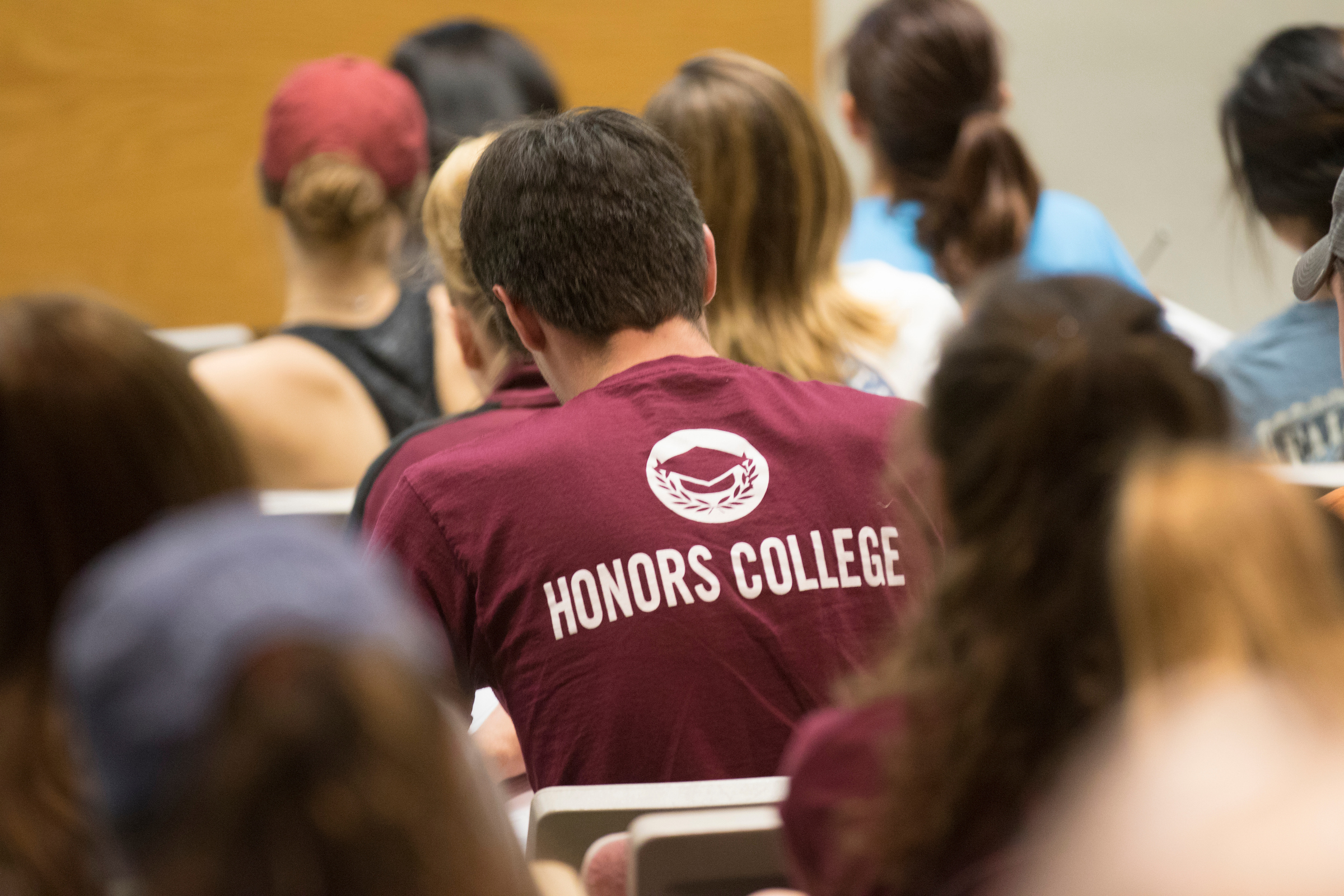 Student wearing honors college shirt in class